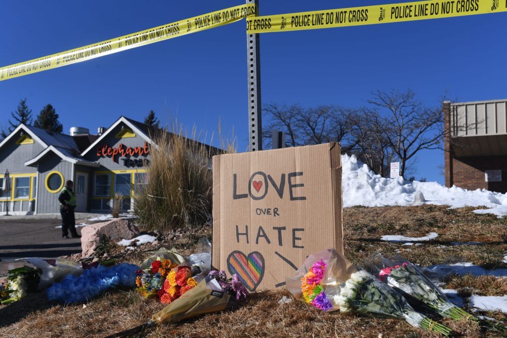 Bouquets of flowers and a sign reading "Love Over Hate" are left near Club Q, an LGBTQ nightclub in Colorado Springs, Colorado, on November 20, 2022. - At least five people were killed and 18 wounded in a mass shooting at an LGBTQ nightclub in the US city of Colorado Springs, police said on November 20, 2022. (Photo by Jason Connolly / AFP) (Photo by JASON CONNOLLY/AFP via Getty Images)