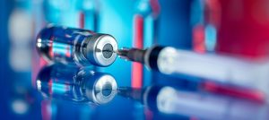 Image of a syringe going into a vial of medication