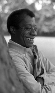 Photograph of James Baldwin smiling