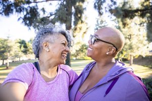 Photo of an older lesbian couple looking at each other lovingly